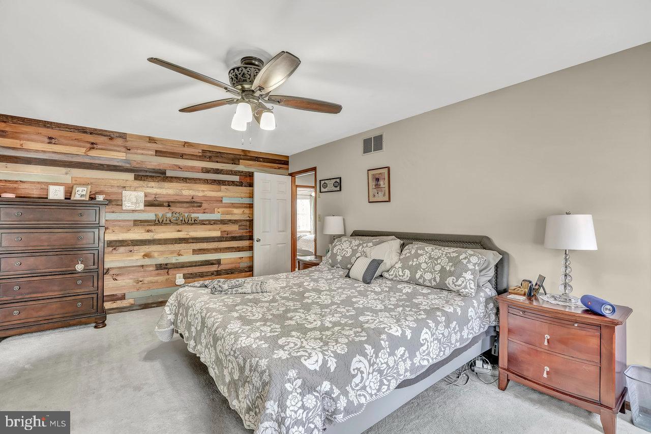 1 Washington Way Tabernacle, NJ 08088 - Photo 19 of 37 a bedroom with a bed and a chandelier