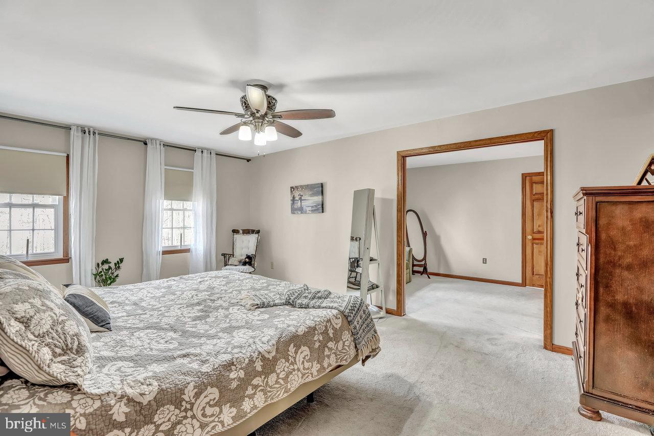 1 Washington Way Tabernacle, NJ 08088 - Photo 20 of 37 a spacious bedroom with a bed and a chandelier