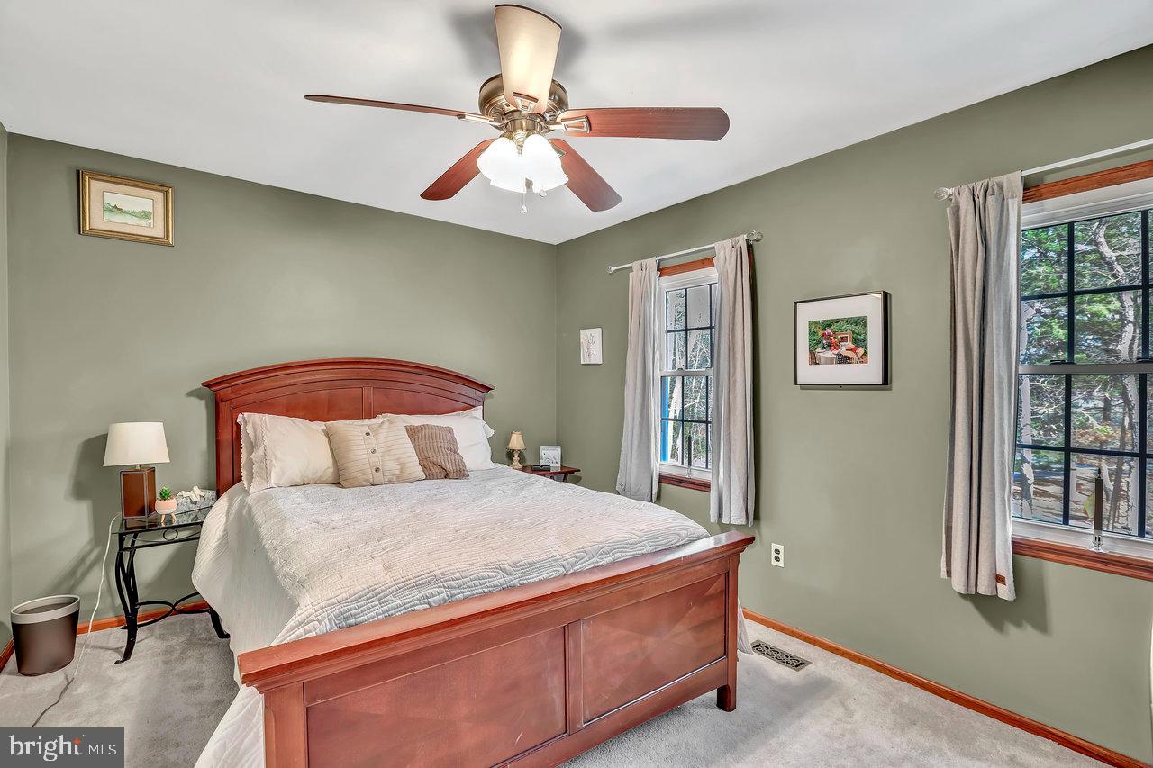 1 Washington Way Tabernacle, NJ 08088 - Photo 28 of 37 a bedroom with a bed and a chandelier