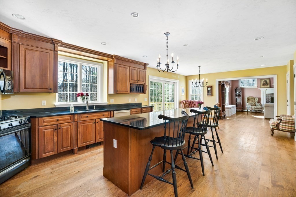 78 Paul Road Hanover, MA 02339 - Photo 2 of 42 a kitchen with stainless steel appliances granite countertop wooden cabinets a dining table and chairs