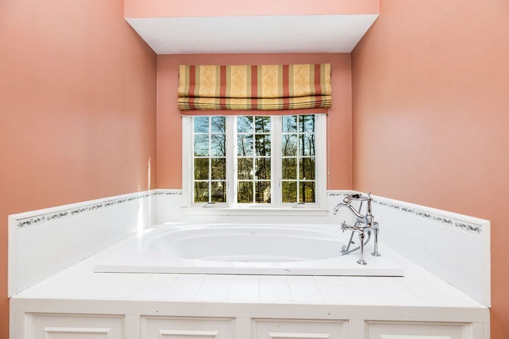 78 Paul Road Hanover, MA 02339 - Photo 21 of 42 a bathroom with a bathtub and a window