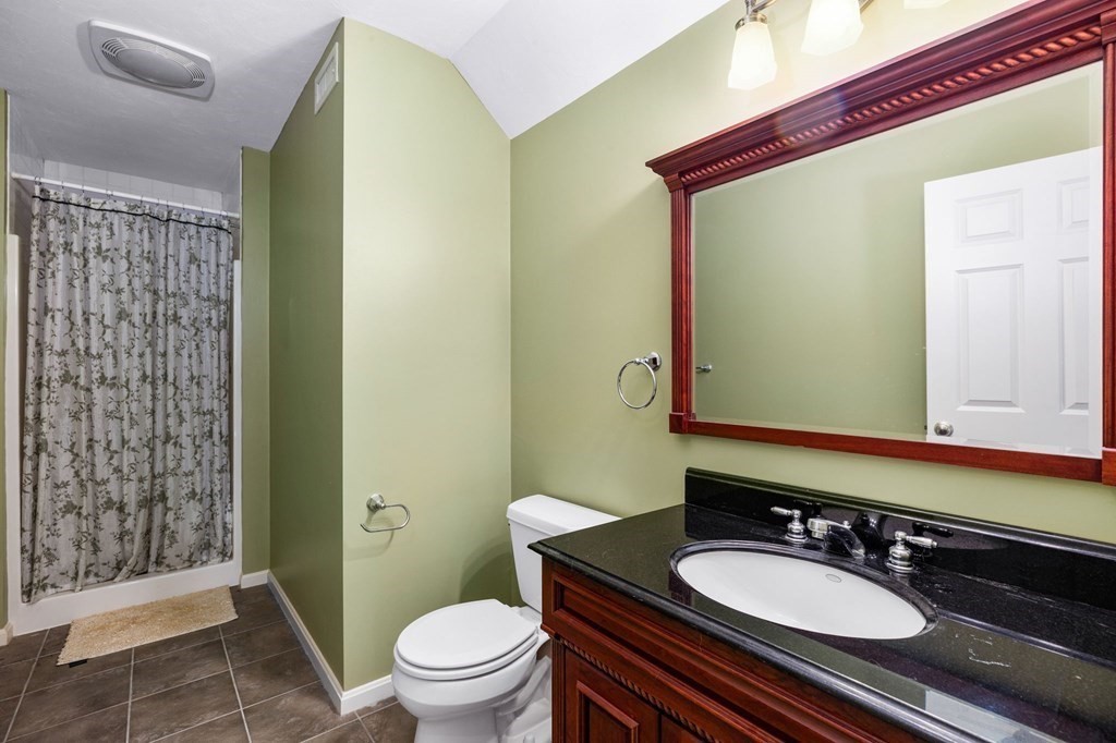 78 Paul Road Hanover, MA 02339 - Photo 30 of 42 a bathroom with a granite countertop sink toilet a mirror and shower