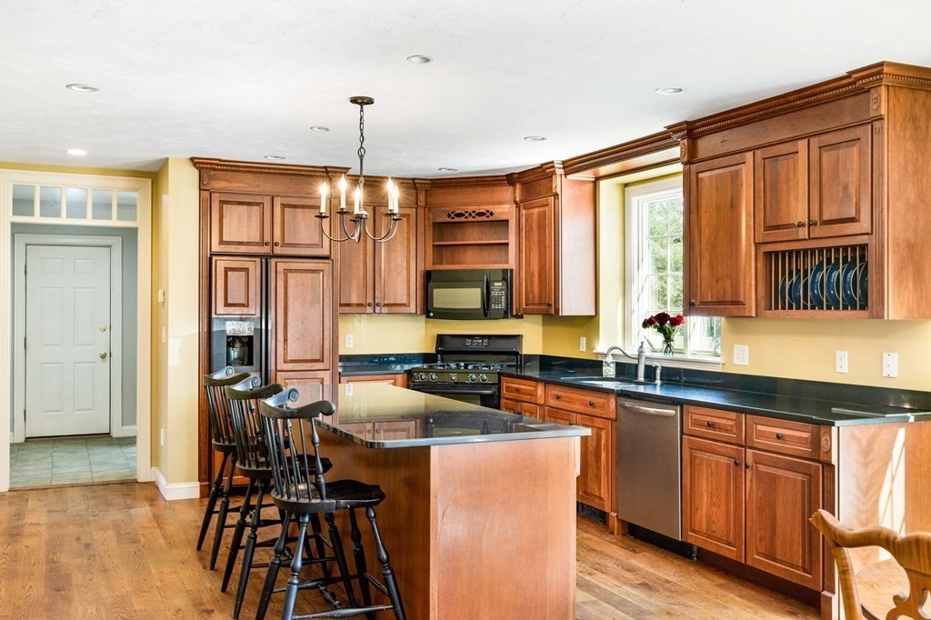 78 Paul Road Hanover, MA 02339 - Photo 3 of 42 a kitchen with granite countertop a stove a sink and a refrigerator
