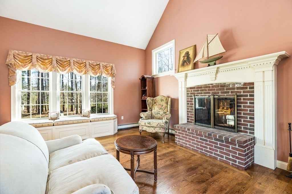 78 Paul Road Hanover, MA 02339 - Photo 9 of 42 a living room with furniture a fireplace and a floor to ceiling window