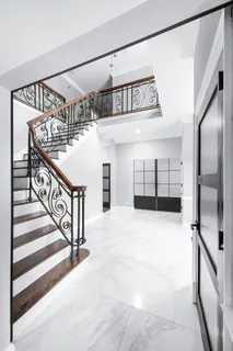 a kitchen with stainless steel appliances kitchen island granite countertop a refrigerator a stove and a sink