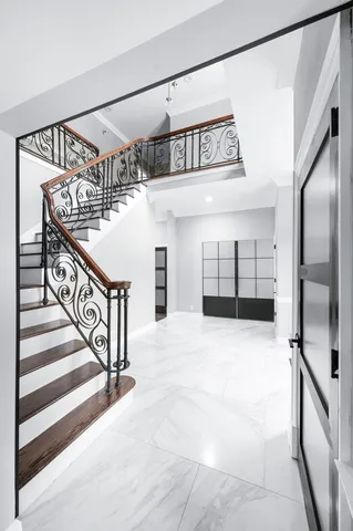 a kitchen with stainless steel appliances kitchen island granite countertop a refrigerator a stove and a sink