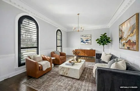 a kitchen with stainless steel appliances granite countertop a refrigerator a stove and a dining table with wooden floor