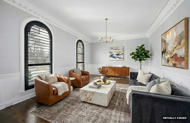 a kitchen with stainless steel appliances granite countertop a refrigerator a stove and a dining table with wooden floor