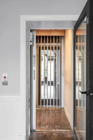 a view of an entryway with wooden floor and a floor to ceiling window