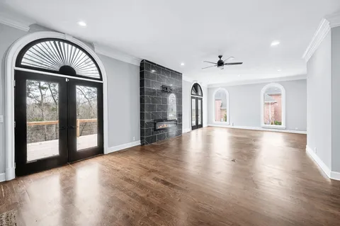 a en suite bathroom with a granite countertop sink and a mirror