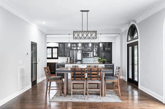 a bathroom with a granite countertop double vanity sink a mirror and a shower