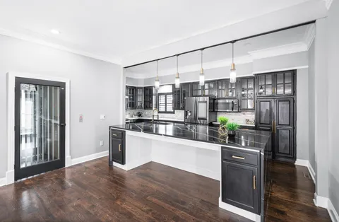 an empty room with windows and ceiling fan