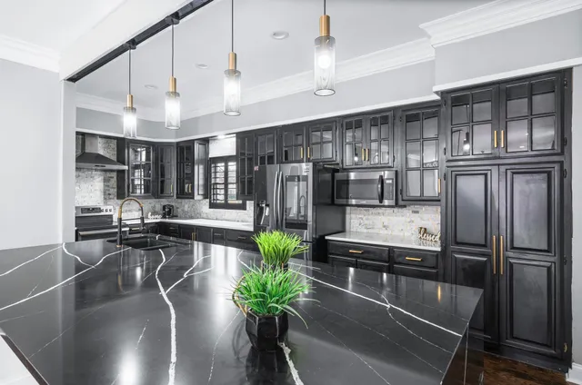 a view of a big room with windows and chandelier fan