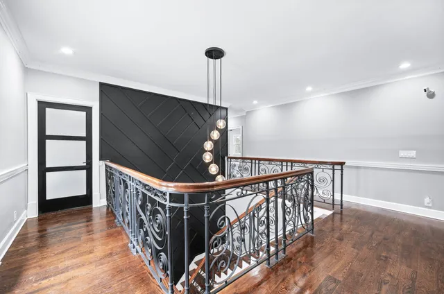 a patio with table and chairs and wooden floor