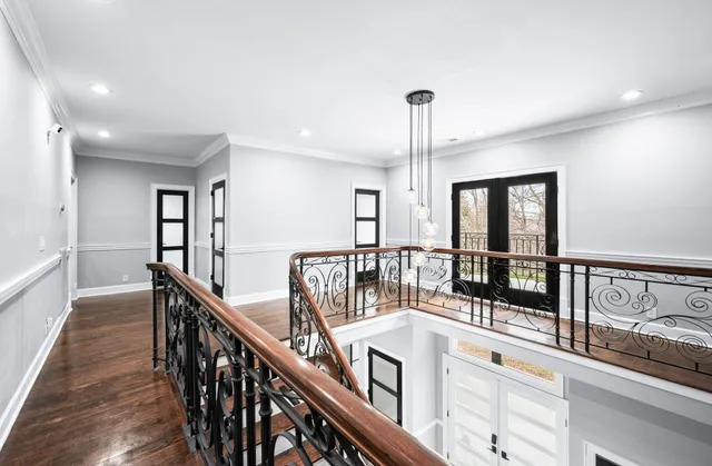 a view of a white house with a yard covered in snow