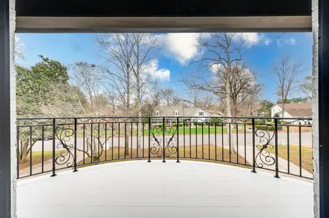 a view of a white house with a yard
