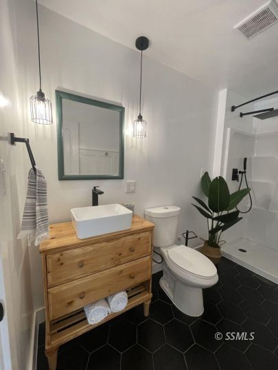 432 West Howell Avenue Ridgecrest, CA 93555 - Photo 12 of 28 a bathroom with a sink toilet and mirror