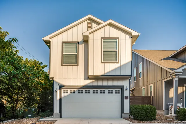 a view of a house with a garage and balcony