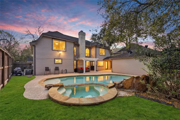 a front view of a house with swimming pool having outdoor seating