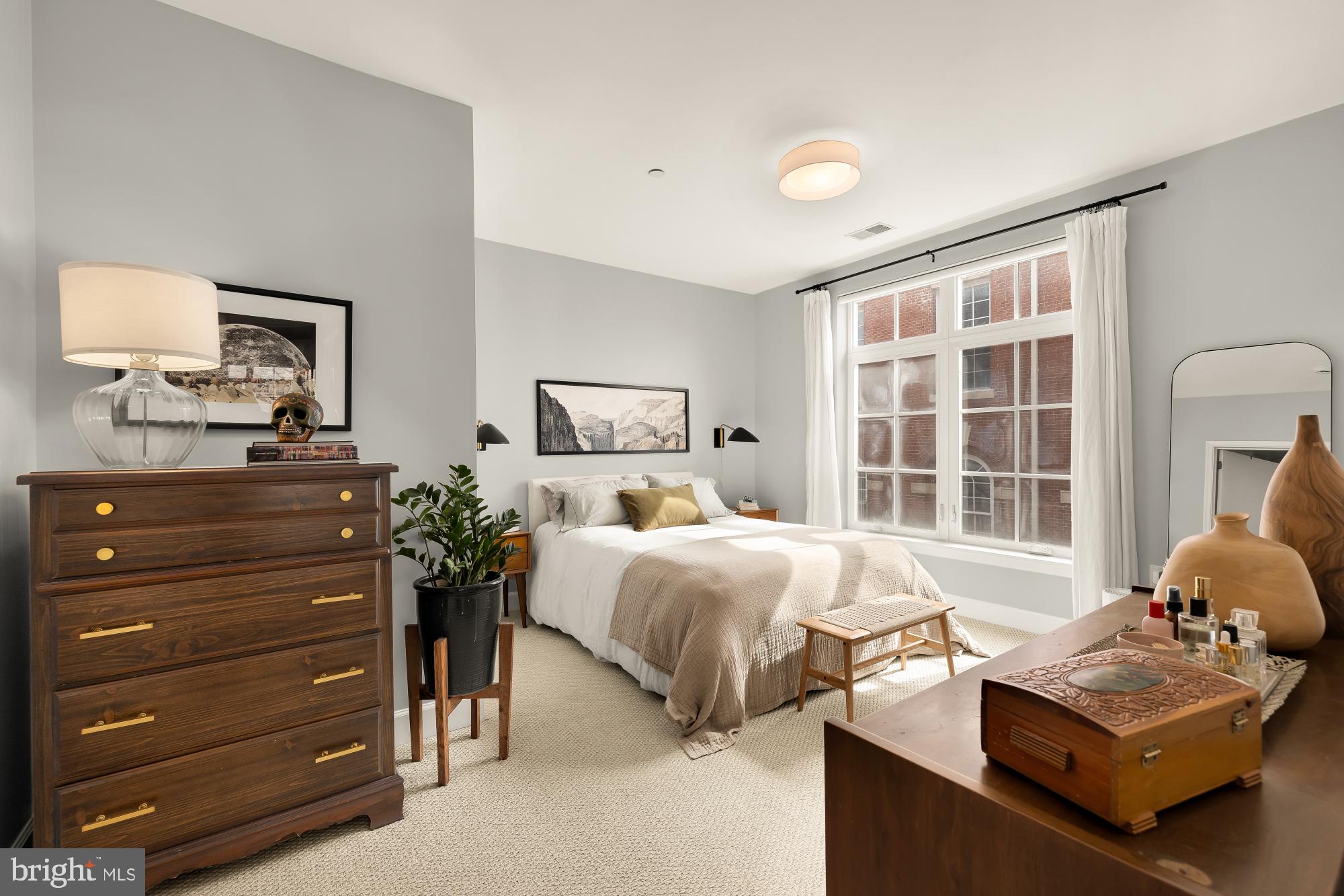 150 V Street Northwest, Unit V204 Washington, DC 20001 - Photo 11 of 26 a bedroom with a bed and wooden floor