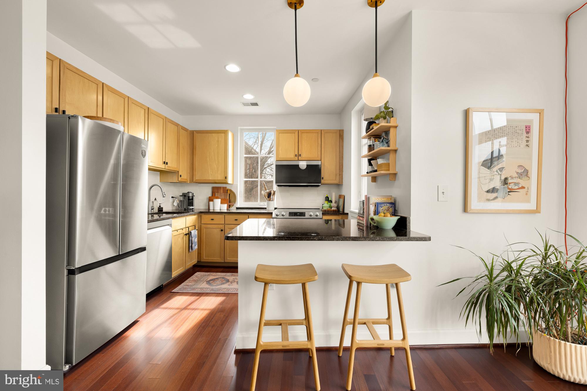 150 V Street Northwest, Unit V204 Washington, DC 20001 - Photo 6 of 26 a kitchen with stainless steel appliances granite countertop a refrigerator a sink dishwasher a stove and white cabinets with wooden floor