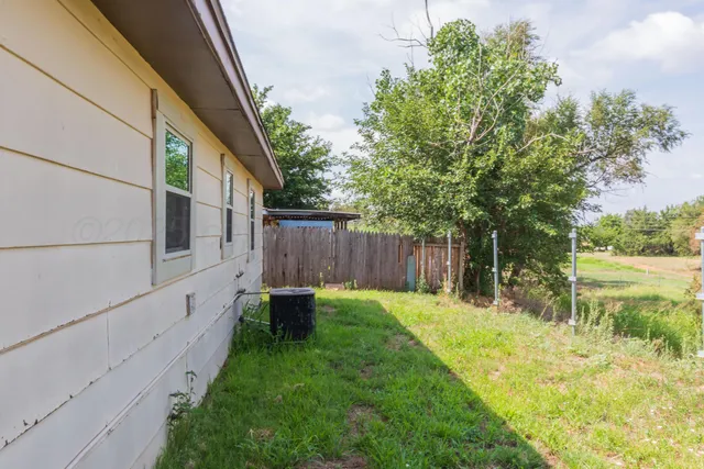a view of backyard with small cabin
