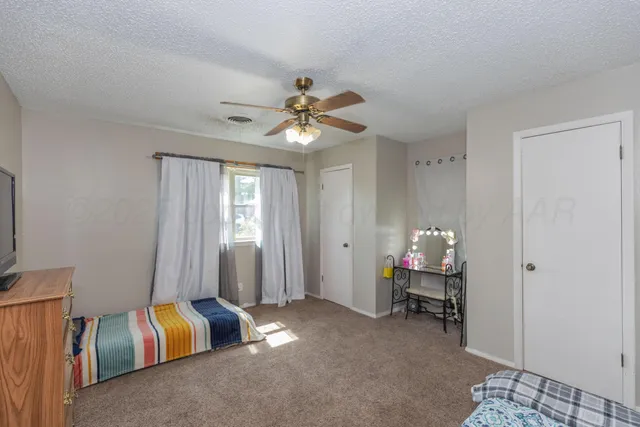 a living room with furniture gym equipment and a window
