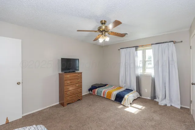 a bed room with a bed and a window