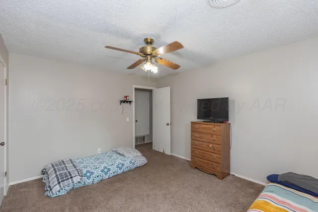 a bedroom with a bed and a television