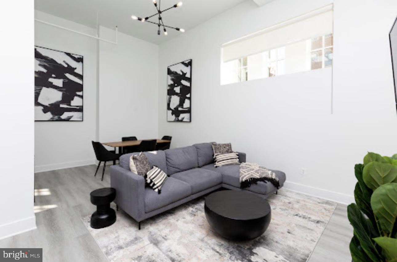a living room with furniture and a chandelier