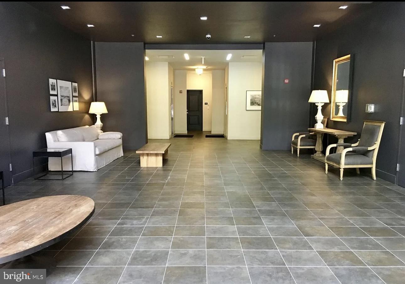 300 Cathedral Street, Unit 106 Baltimore, MD 21201 - Photo 14 of 16 a lobby with furniture and a potted plant