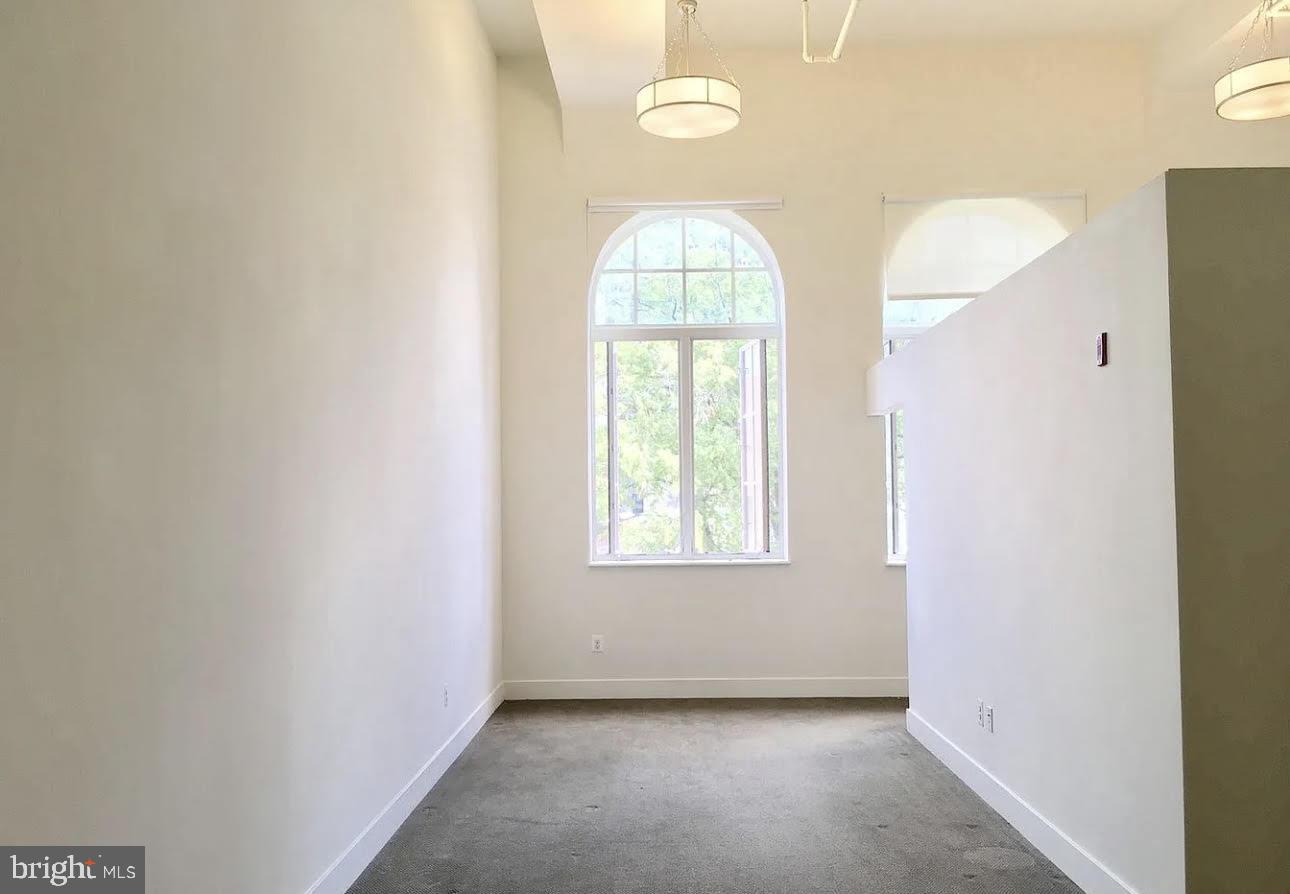 300 Cathedral Street, Unit 106 Baltimore, MD 21201 - Photo 9 of 16 an empty room with windows and mirror