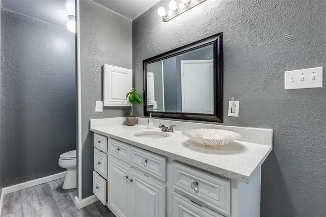 a bathroom with a sink and a mirror with toilet