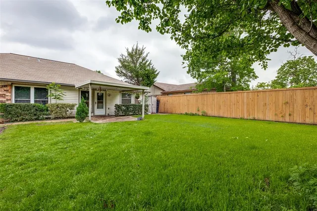 a view of a house with a yard and a garden