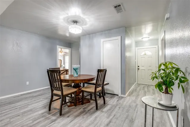 a view of a dining room with furniture and a chandelier