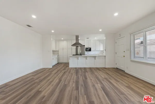 a view of kitchen with wooden floor and window