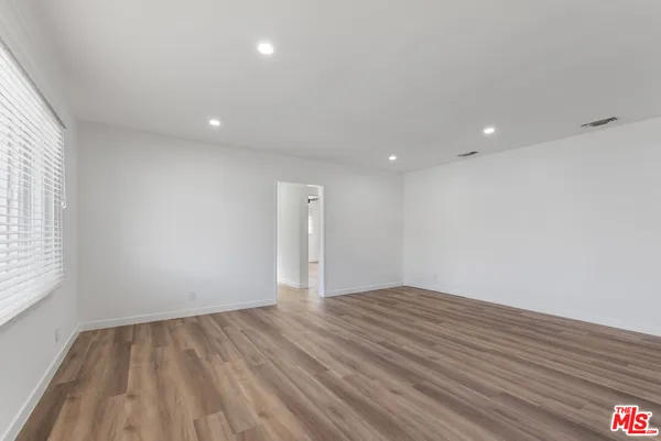 a view of room with window and wooden floor