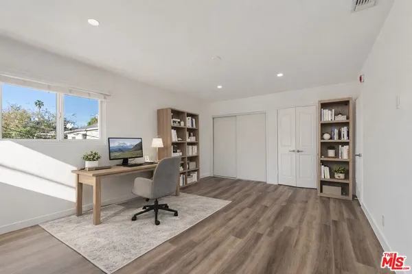 a workspace with furniture and wooden floor