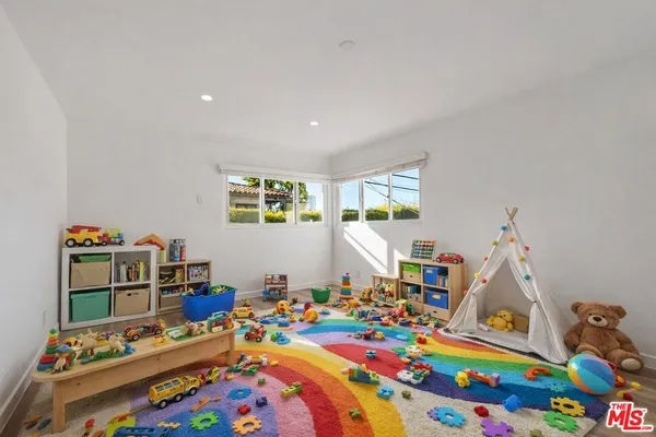 a bed room with furniture and a baby crib