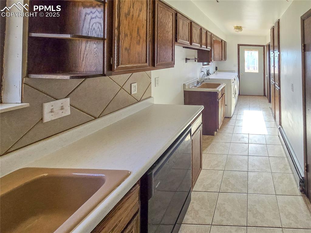 722 6th Street Hugo, CO 80821 - Photo 17 of 35 a kitchen with stainless steel appliances a sink a stove and cabinets