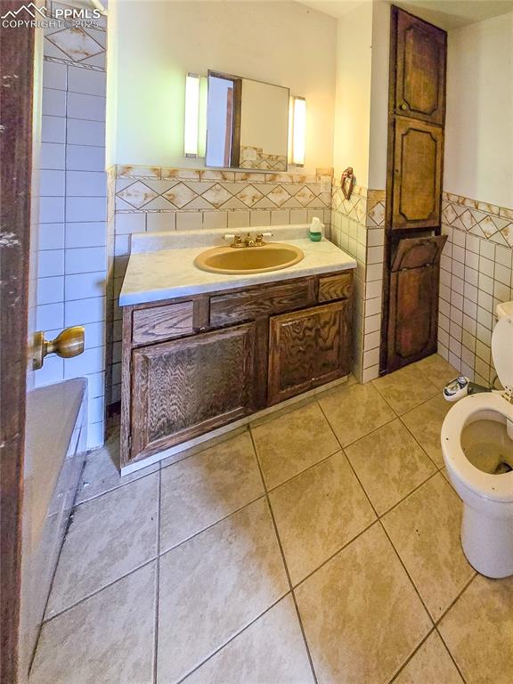 722 6th Street Hugo, CO 80821 - Photo 22 of 35 a bathroom with a sink a toilet and mirror