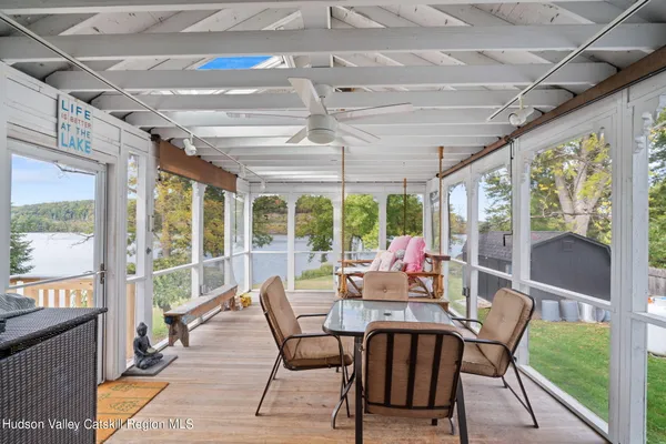 a view of a dining room with furniture large windows and wooden floor