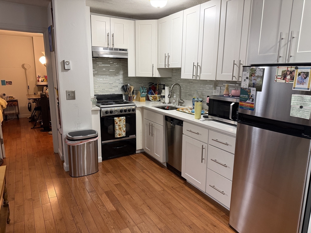 32 Fleet Street, Unit B Boston, MA 02113 - Photo 3 of 7 a kitchen with a sink cabinets and wooden floor