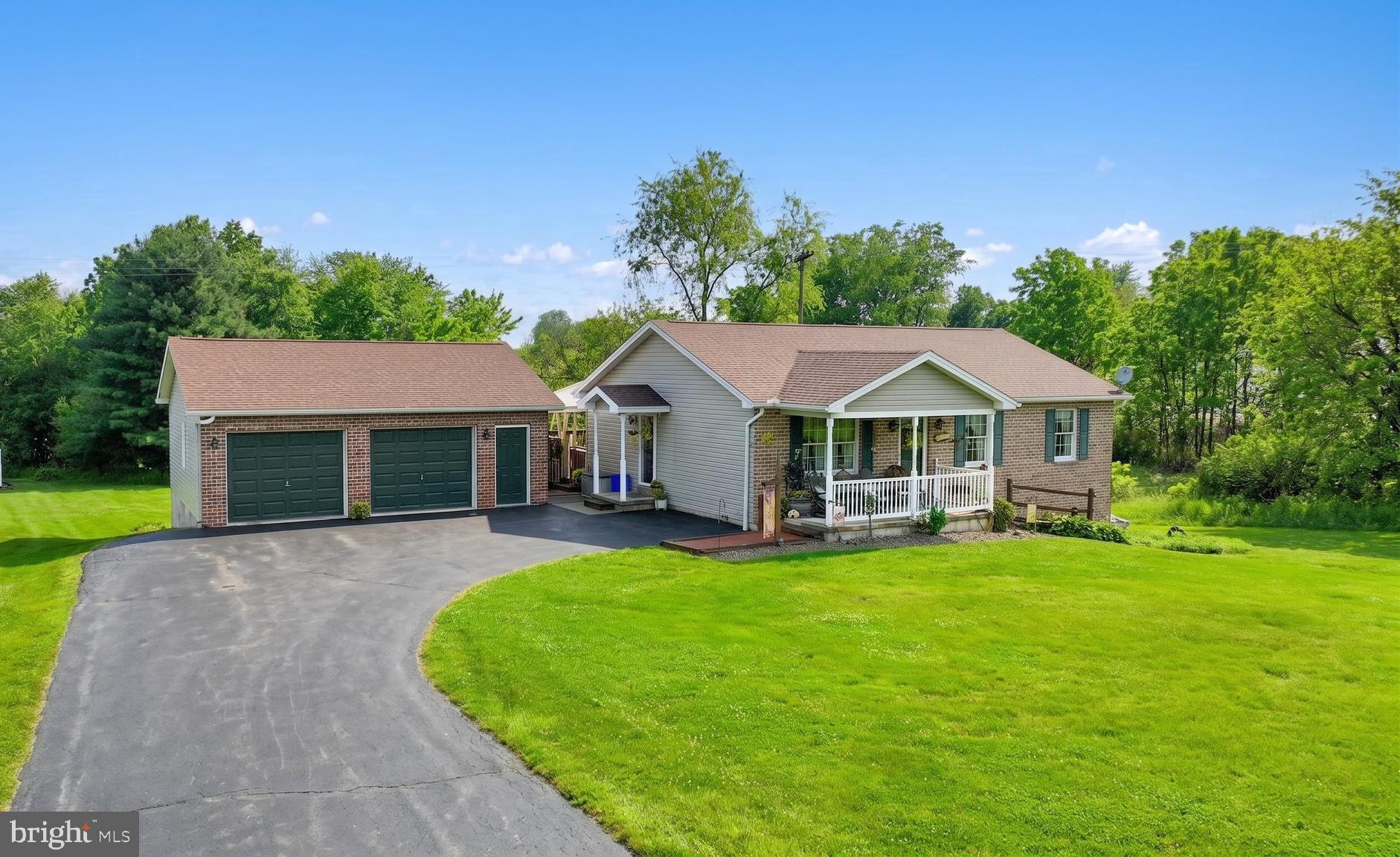 a front view of house with yard and green space