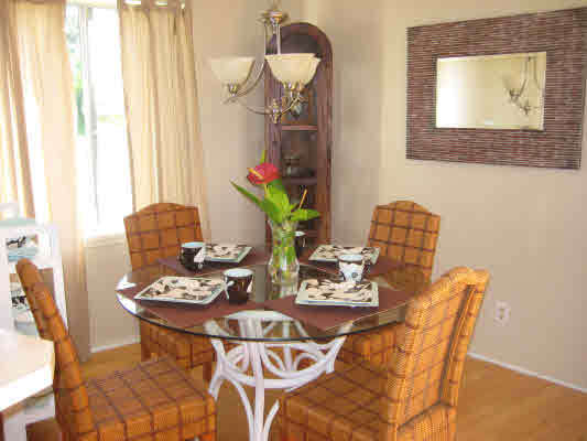 3780 Edward Road, Unit 5201 Princeville, HI 96722 - Photo 12 of 23 a view of a dining room with furniture and a potted plant
