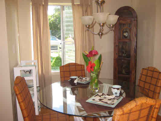 3780 Edward Road, Unit 5201 Princeville, HI 96722 - Photo 13 of 23 a view of a dining room with furniture and a window