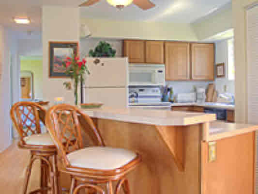 3780 Edward Road, Unit 5201 Princeville, HI 96722 - Photo 14 of 23 a kitchen with stainless steel appliances granite countertop a sink and a refrigerator