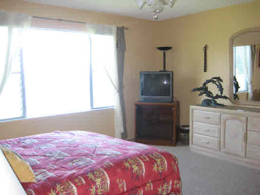 3780 Edward Road, Unit 5201 Princeville, HI 96722 - Photo 18 of 23 a bedroom with a bed and a dresser
