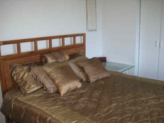 3780 Edward Road, Unit 5201 Princeville, HI 96722 - Photo 21 of 23 a large bed sitting in a bedroom next to a window