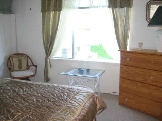 3780 Edward Road, Unit 5201 Princeville, HI 96722 - Photo 22 of 23 a bedroom with a bed and a window